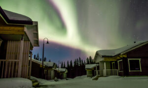 Northern Lights over the Valkea Arctic holiday village in Pello in Lapland, Finland