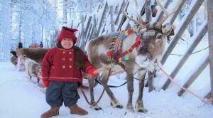 Foto: Kilvo, elfo de Papá Noel y un reno en el Pueblo de Papá Noel en Rovaniemi, Finlandia
