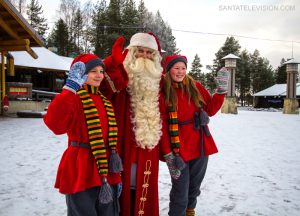 Santa Claus and the elves happy with the first snow in Lapland